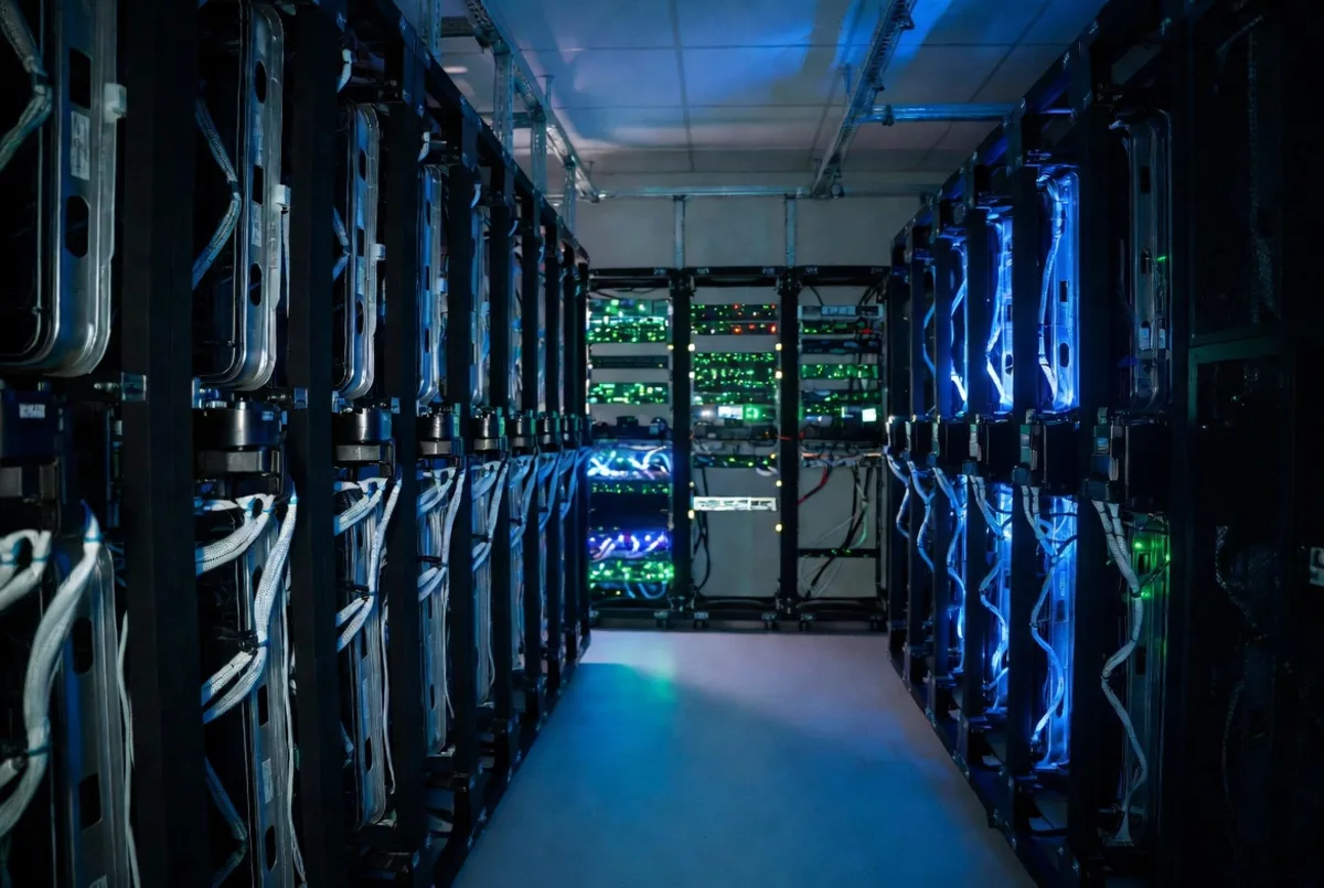 A server room aisle with racks of equipment