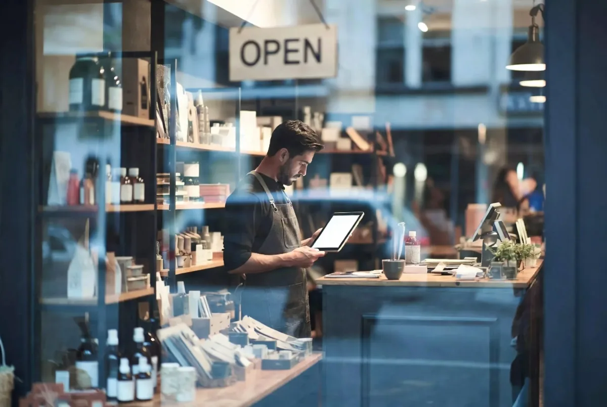 A small business owner with a tablet in their shop