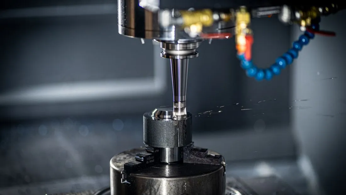 A CNC machine precision-cutting metal on a factory floor
