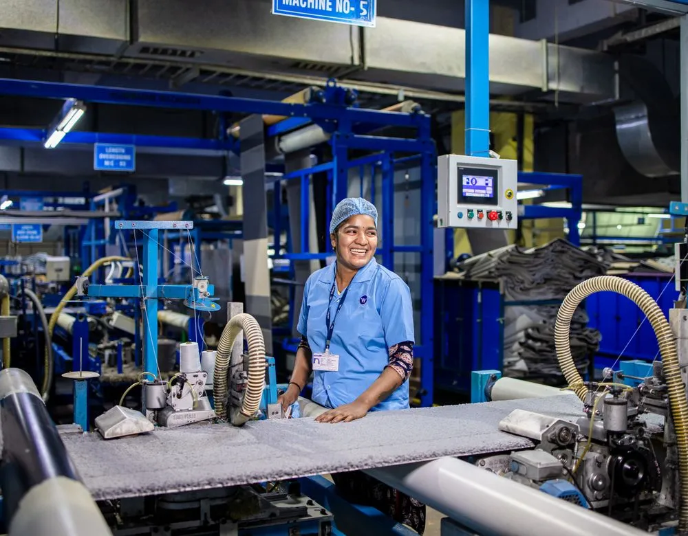 Workers operating machinery on a manufacturing floor — Braintek IT for Houston manufacturers