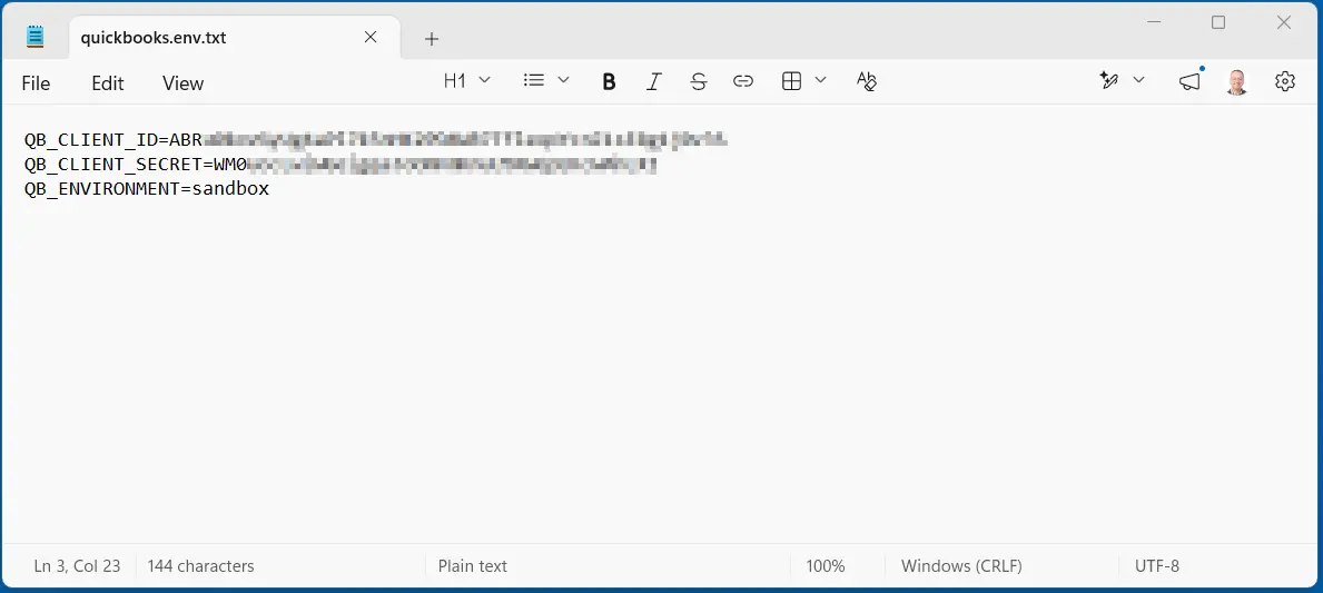 The credentials file in Notepad, with the Client ID and Client Secret values blurred