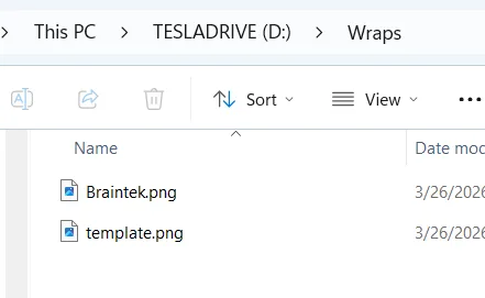 Windows Explorer showing the Wraps folder on the Tesla USB drive with Braintek.png inside