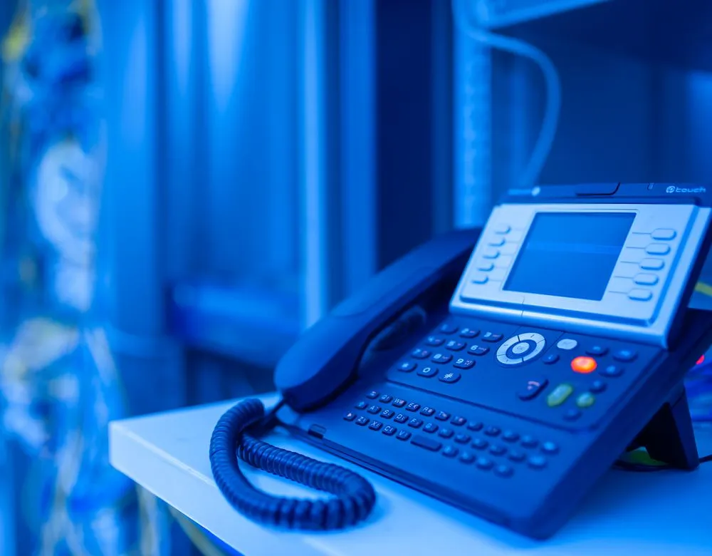 A modern business VoIP desk phone at a Houston office