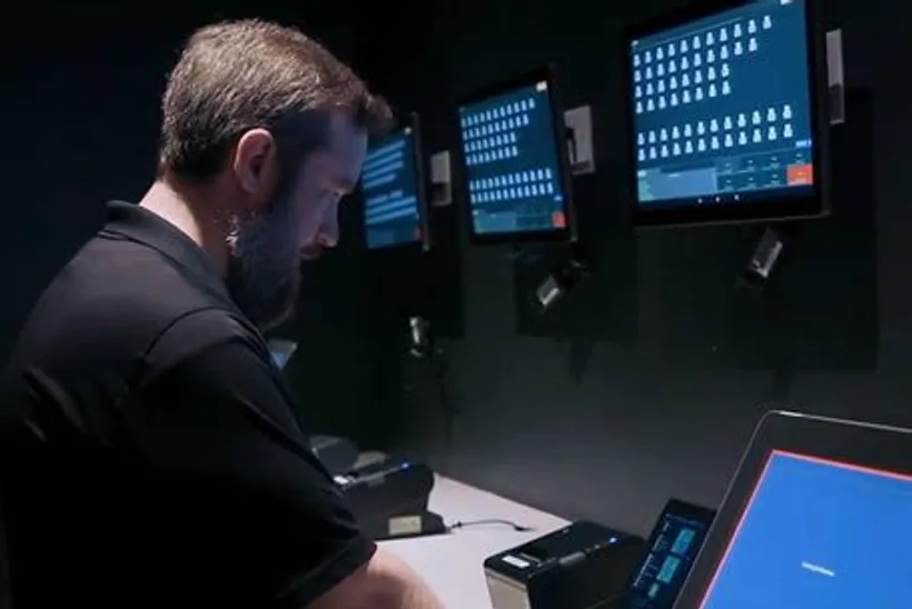 Braintek technician at a multi-screen monitoring console