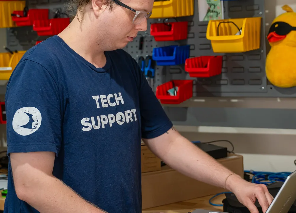 Braintek technician repairing hardware at the workbench